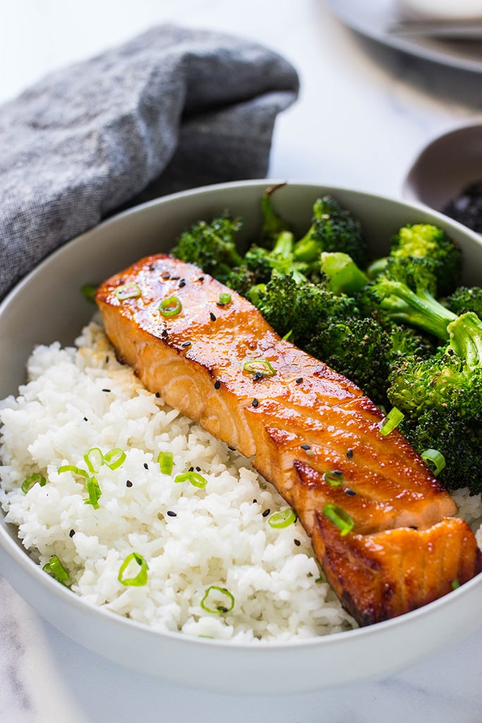 A bowl of honey garlic salmon with rice and broccoli.