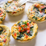 Close up shot of five healthy egg white muffin breakfast cups on a white plate.