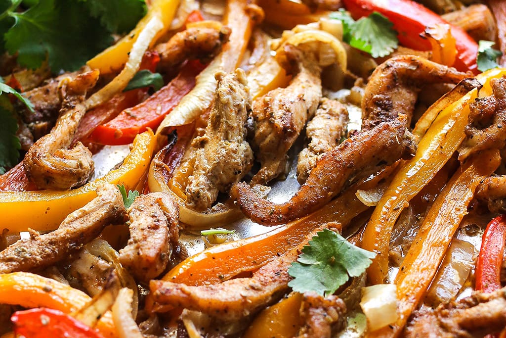 A close up photo of easy sheet pan chicken fajitas.