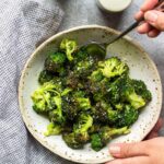 A bowl of crispy air fryer garlic Parmesan broccoli.