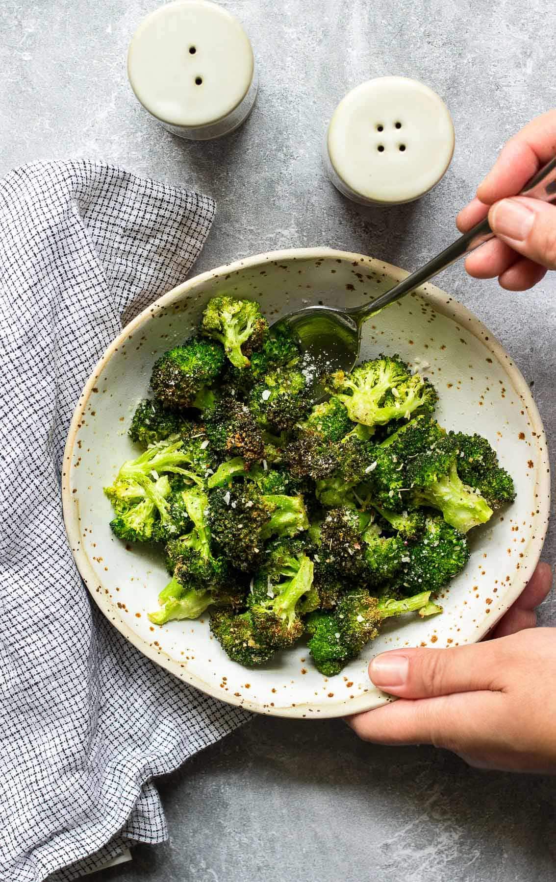 A bowl of crispy air fryer garlic Parmesan broccoli.