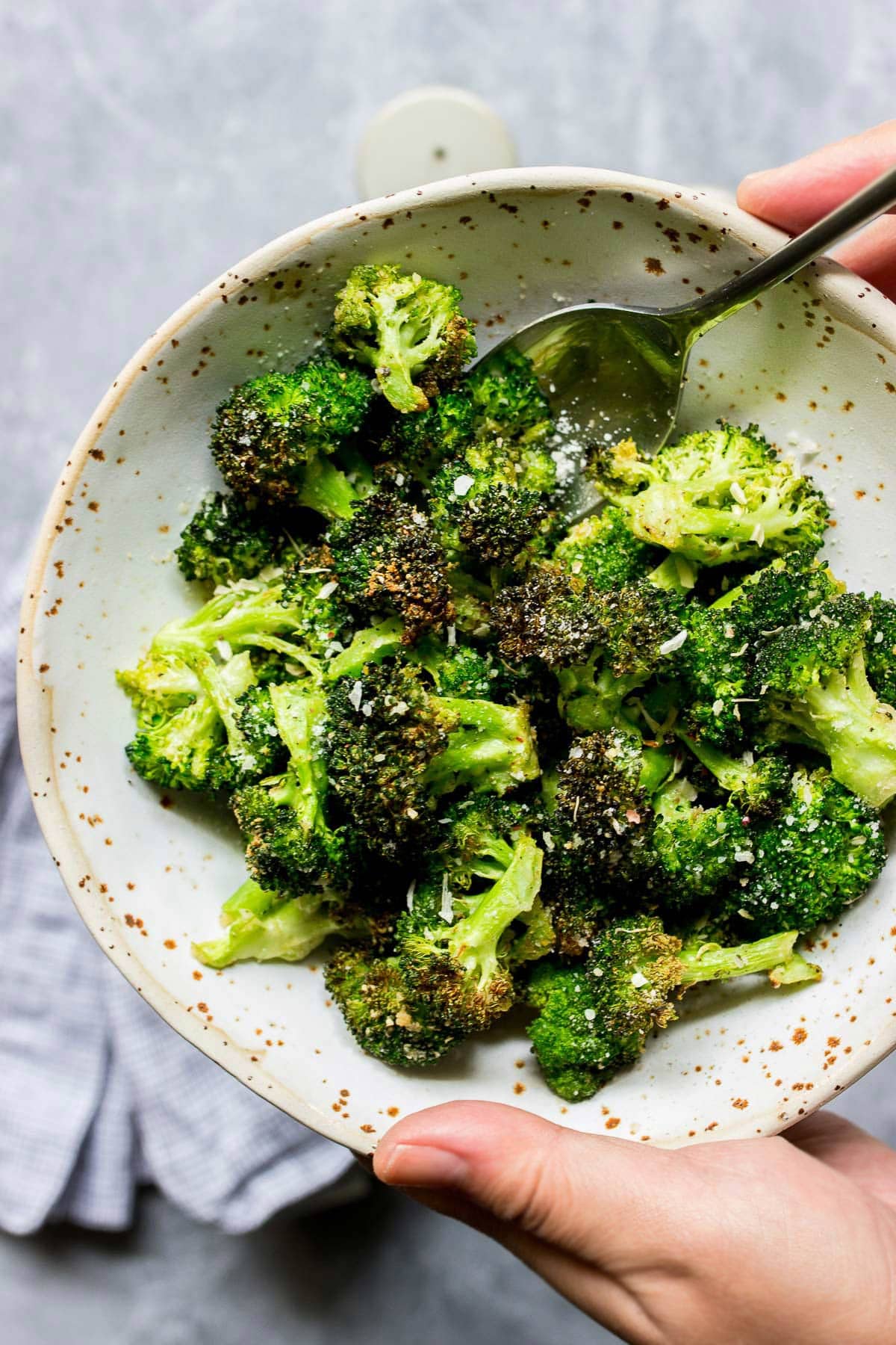 A bowl of crispy air fryer garlic Parmesan broccoli.