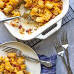 Bacon cheeseburger tater tot casserole in a white casserole dish.