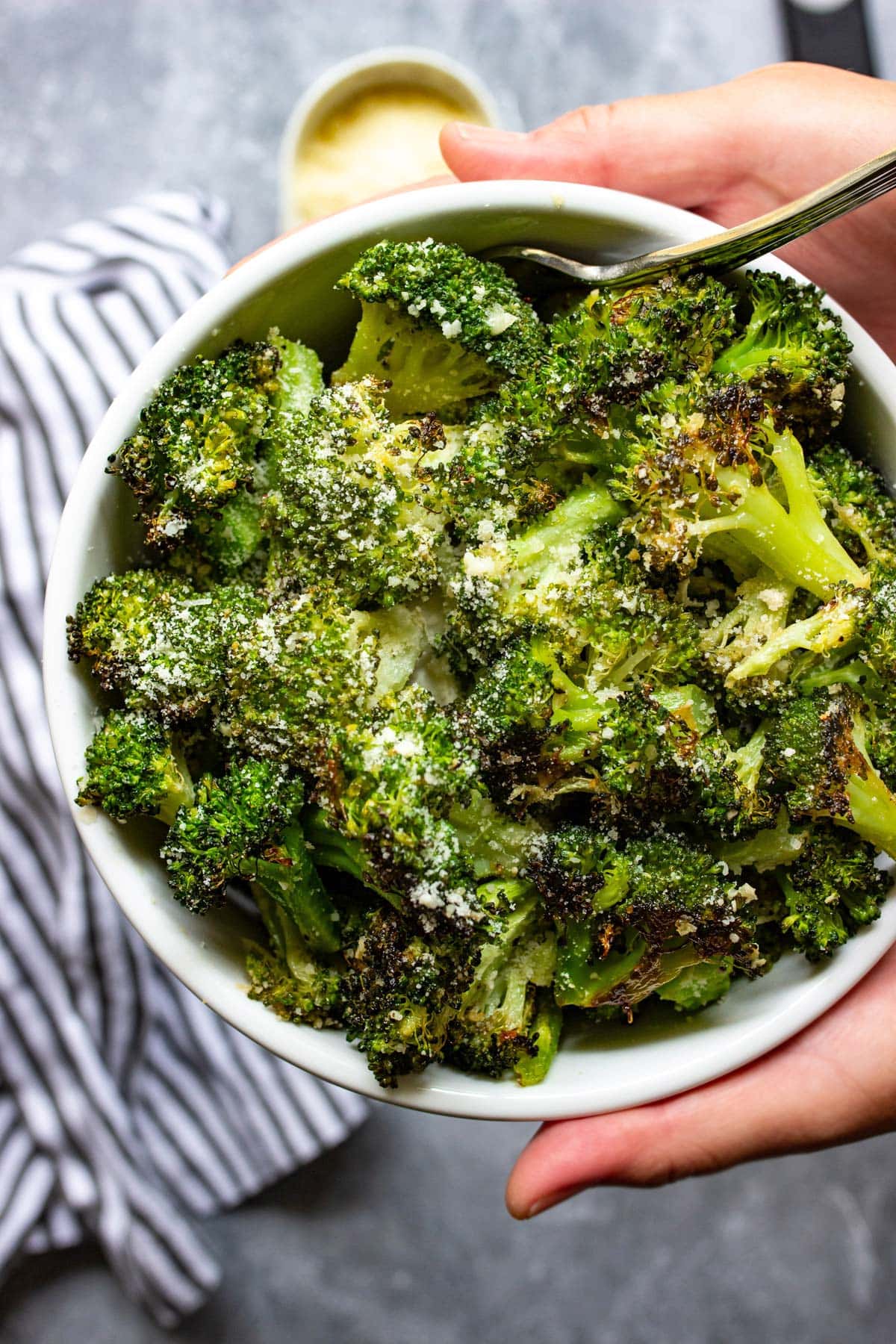 Garlic Parmesan roasted broccoli in a white bowl.