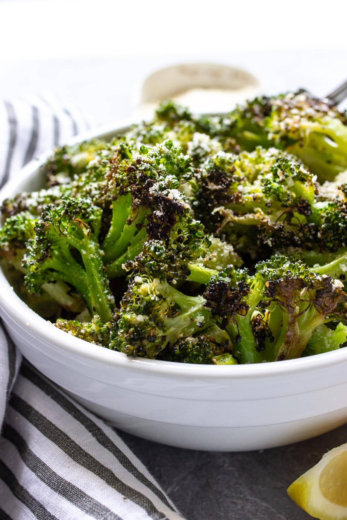 Garlic Parmesan roasted broccoli in a white bowl.