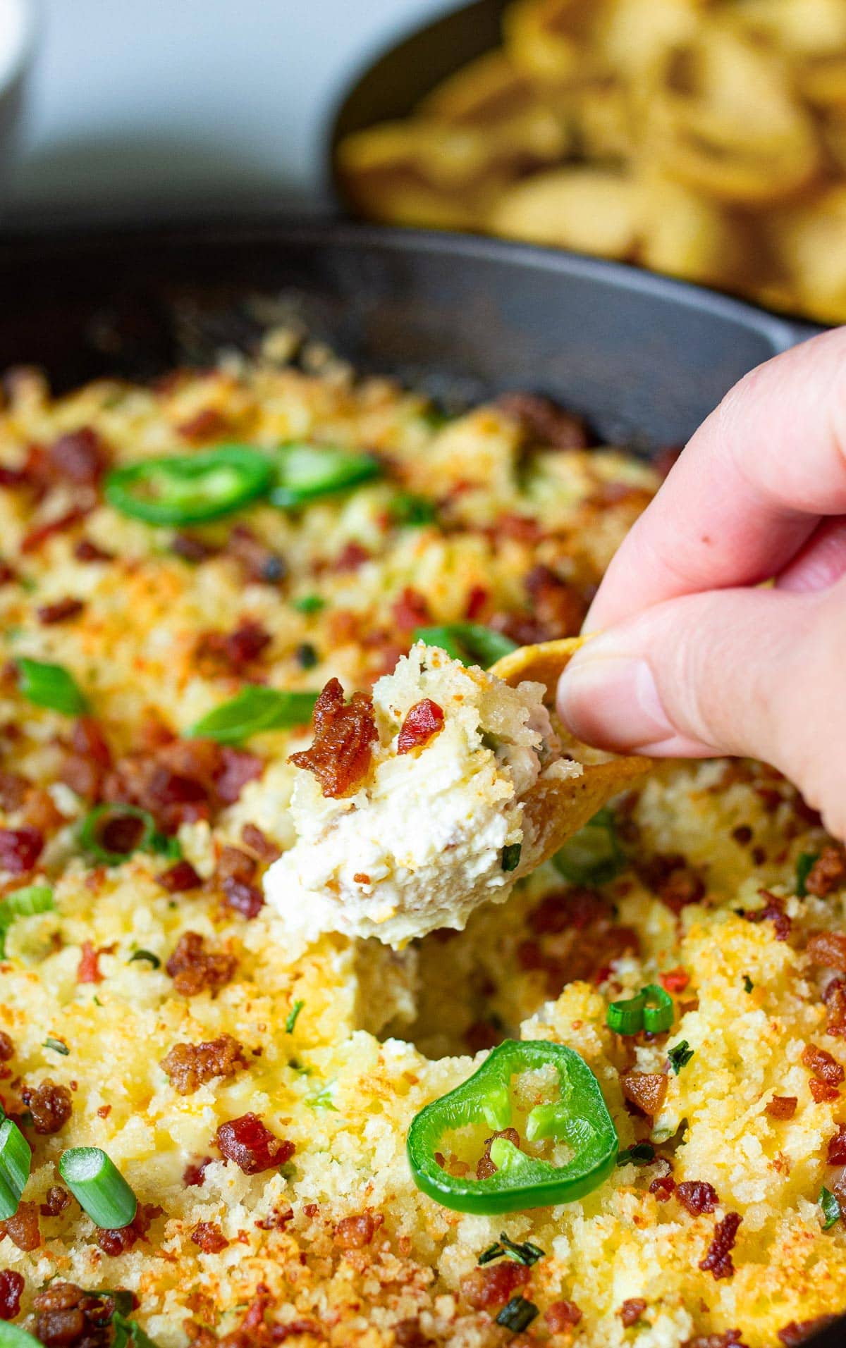 A zoomed in shot of a scooped bite of jalapeno popper dip.