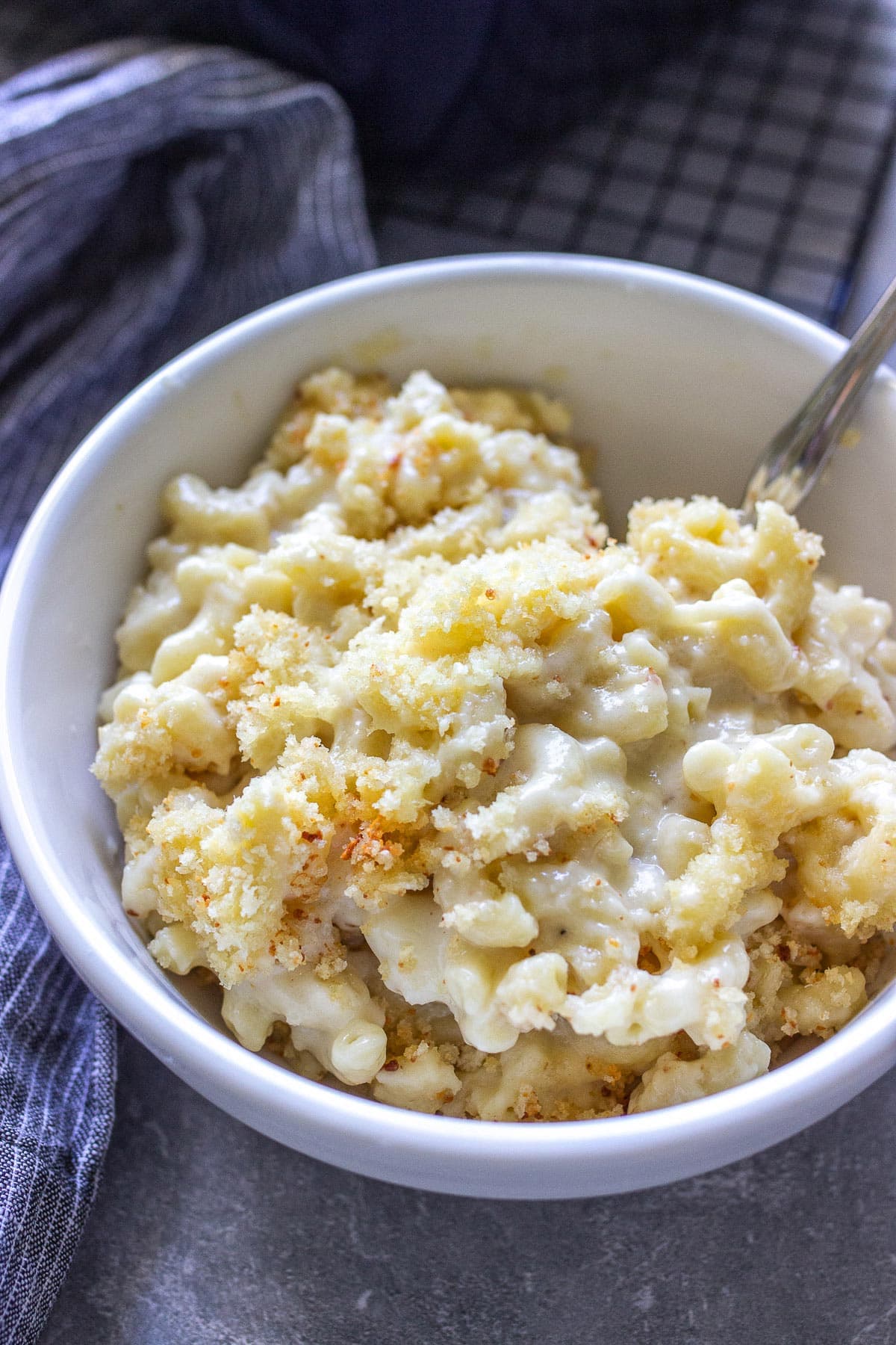 Baked mac and cheese in a white bowl.