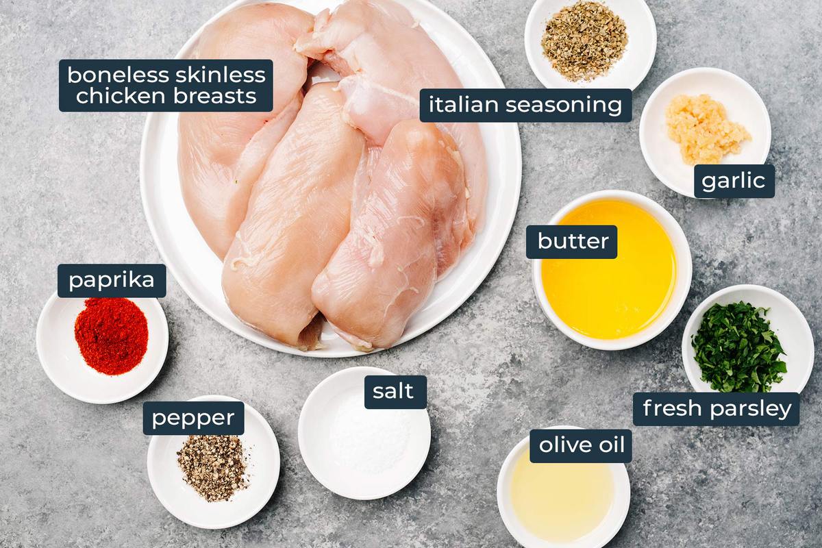 Ingredients to make garlic butter baked chicken breast in prep bowls.