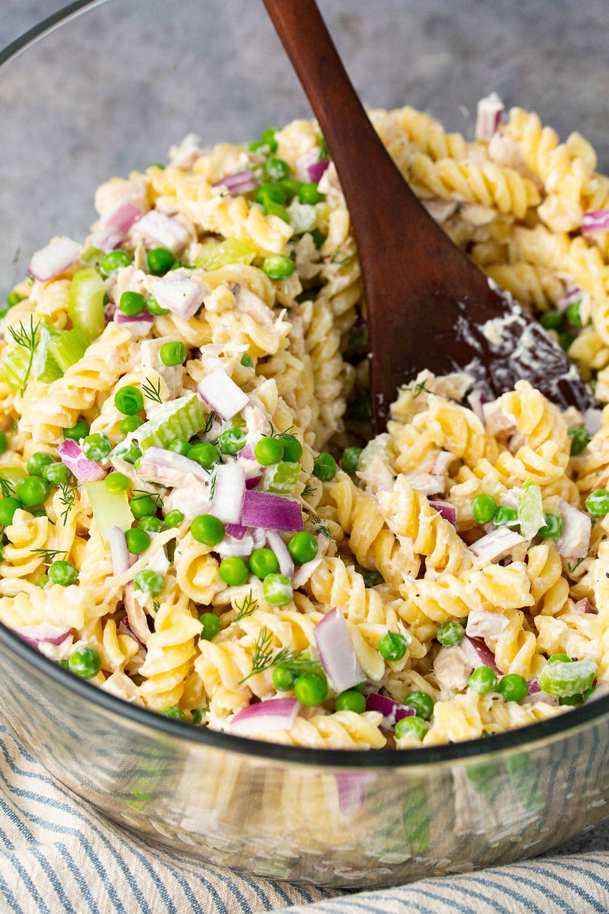 Tuna pasta salad in a large glass mixing bowl.