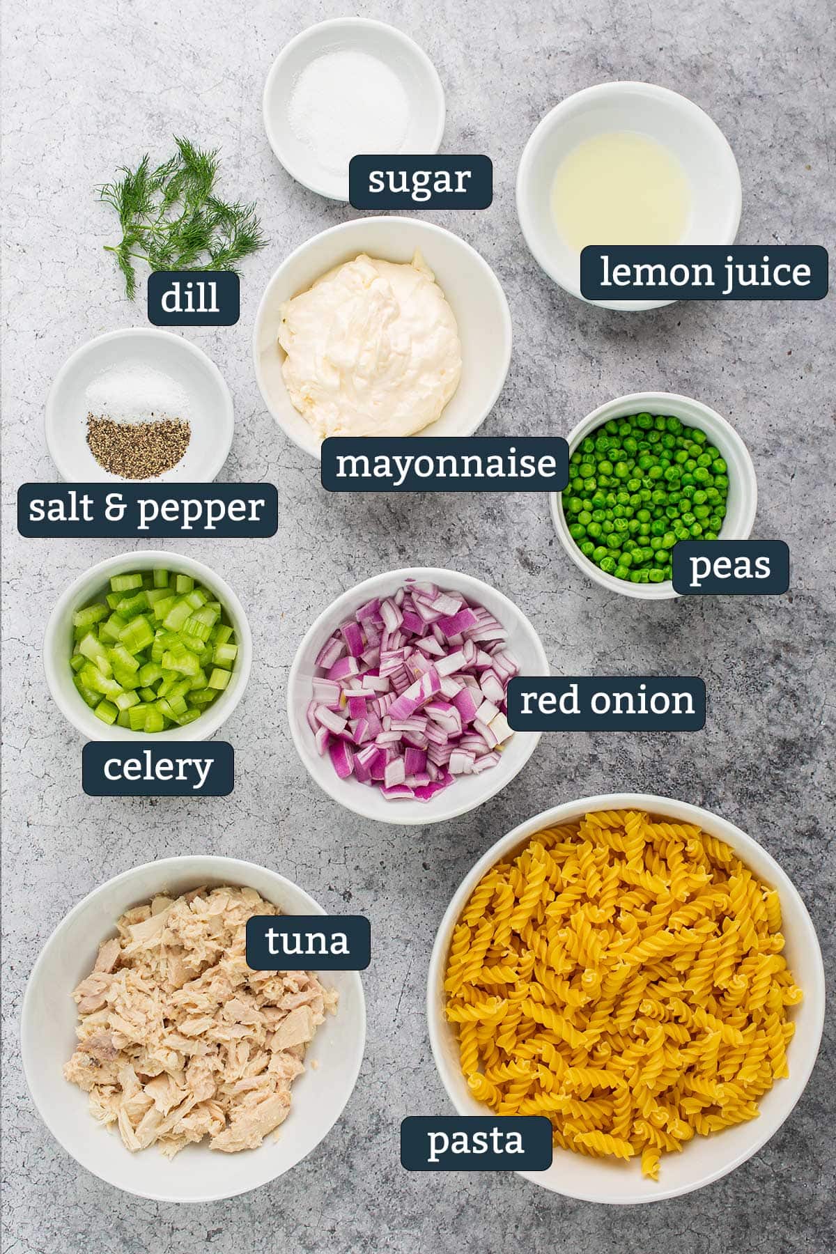 Ingredients to make tuna pasta salad in prep bowls.
