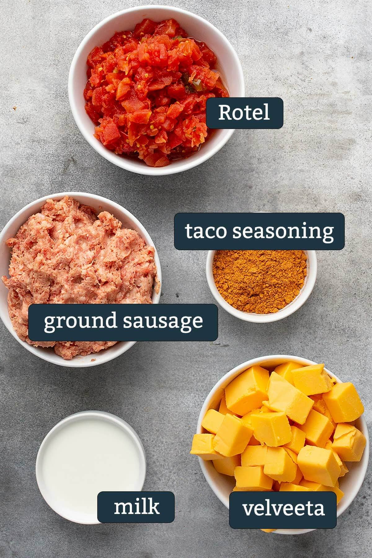 Ingredients to make velveeta Rotel sausage dip in prep bowls.