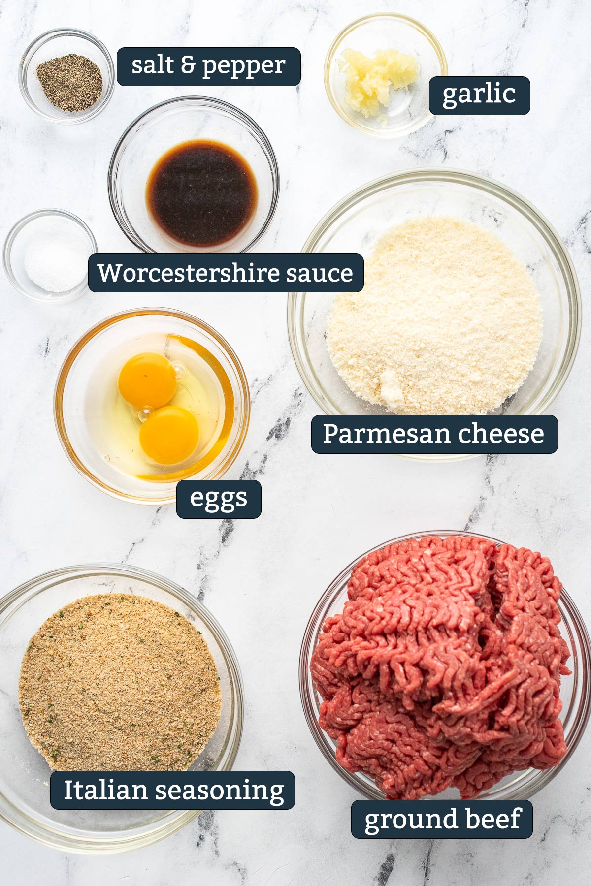 Ingredients to make Parmesan meatballs in glass prep bowls.