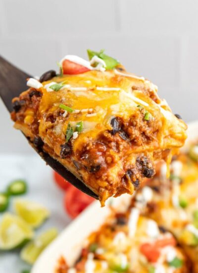 A hearty serving of Mexican ground beef casserole on a wooden spatula.