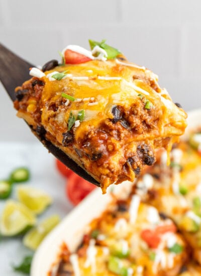 A hearty serving of Mexican ground beef casserole on a wooden spatula.
