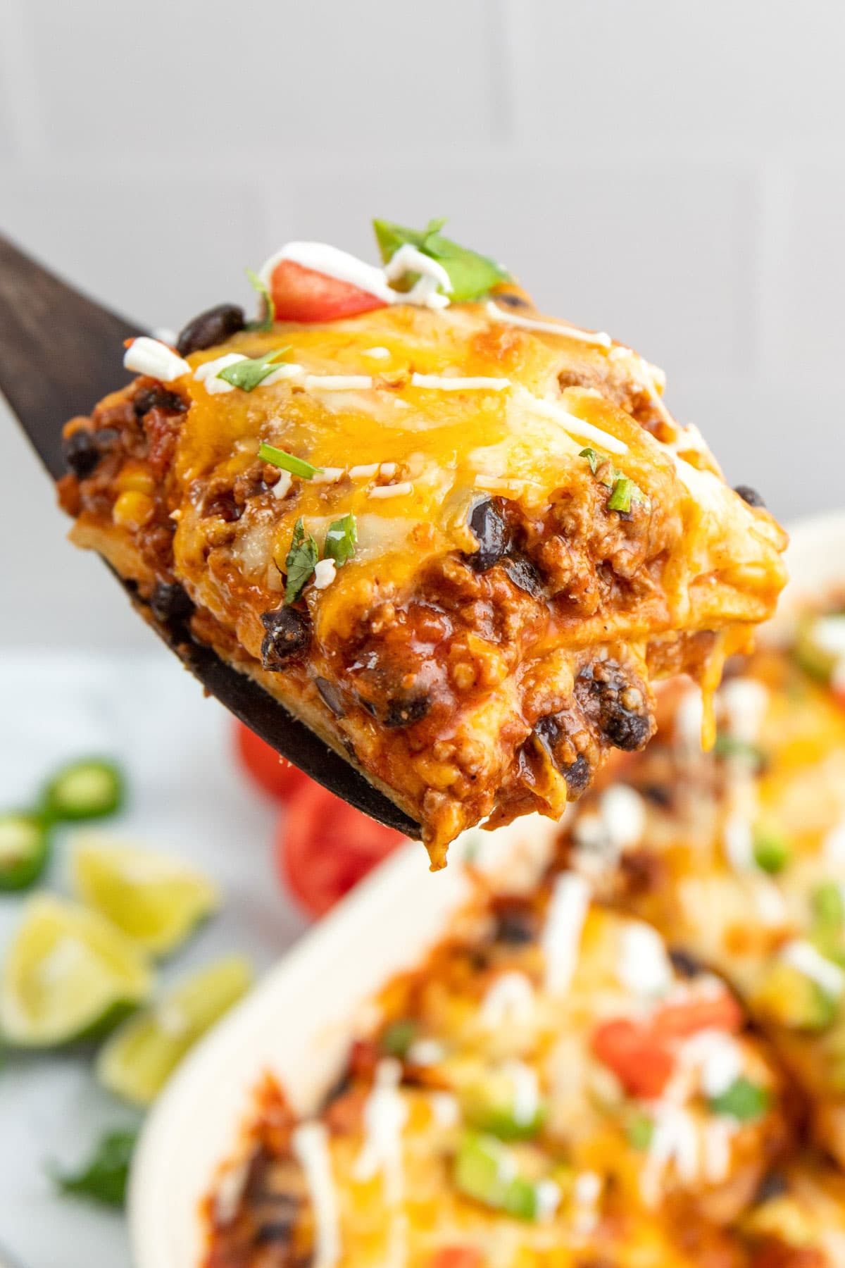 A hearty serving of Mexican ground beef casserole on a wooden spatula.