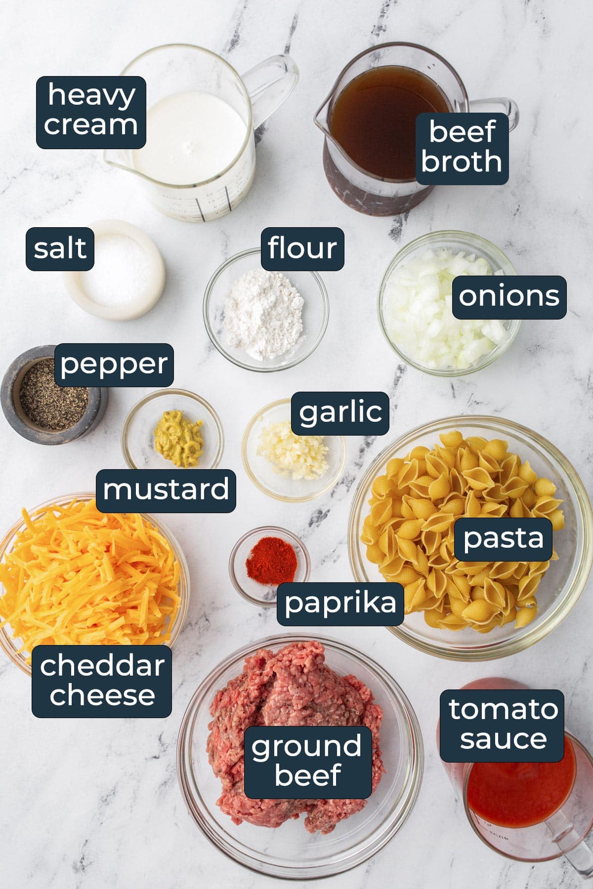 Ingredients to make creamy beef and shells in prep bowls.