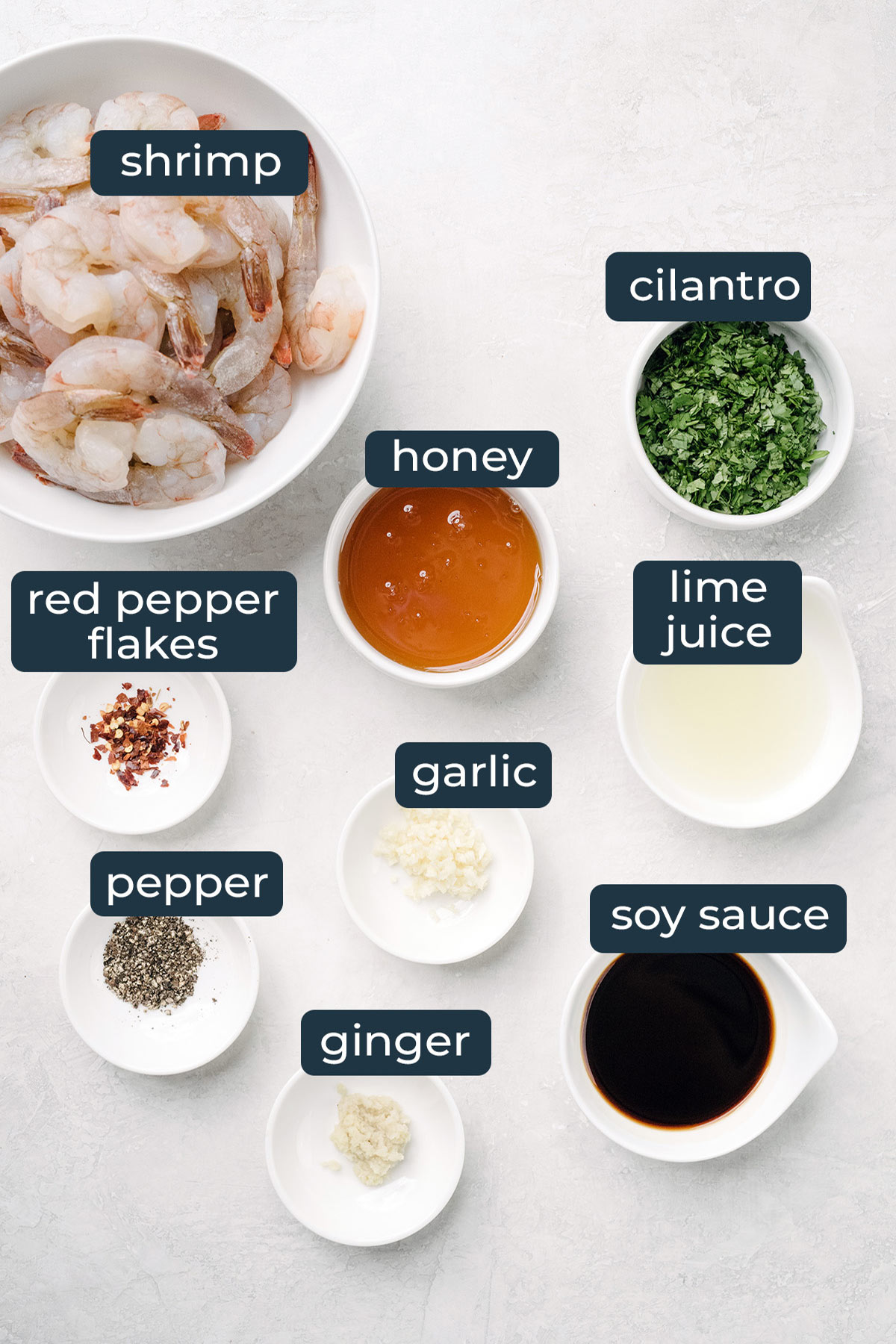 Ingredients to make cilantro lime honey garlic shrimp in prep bowls.