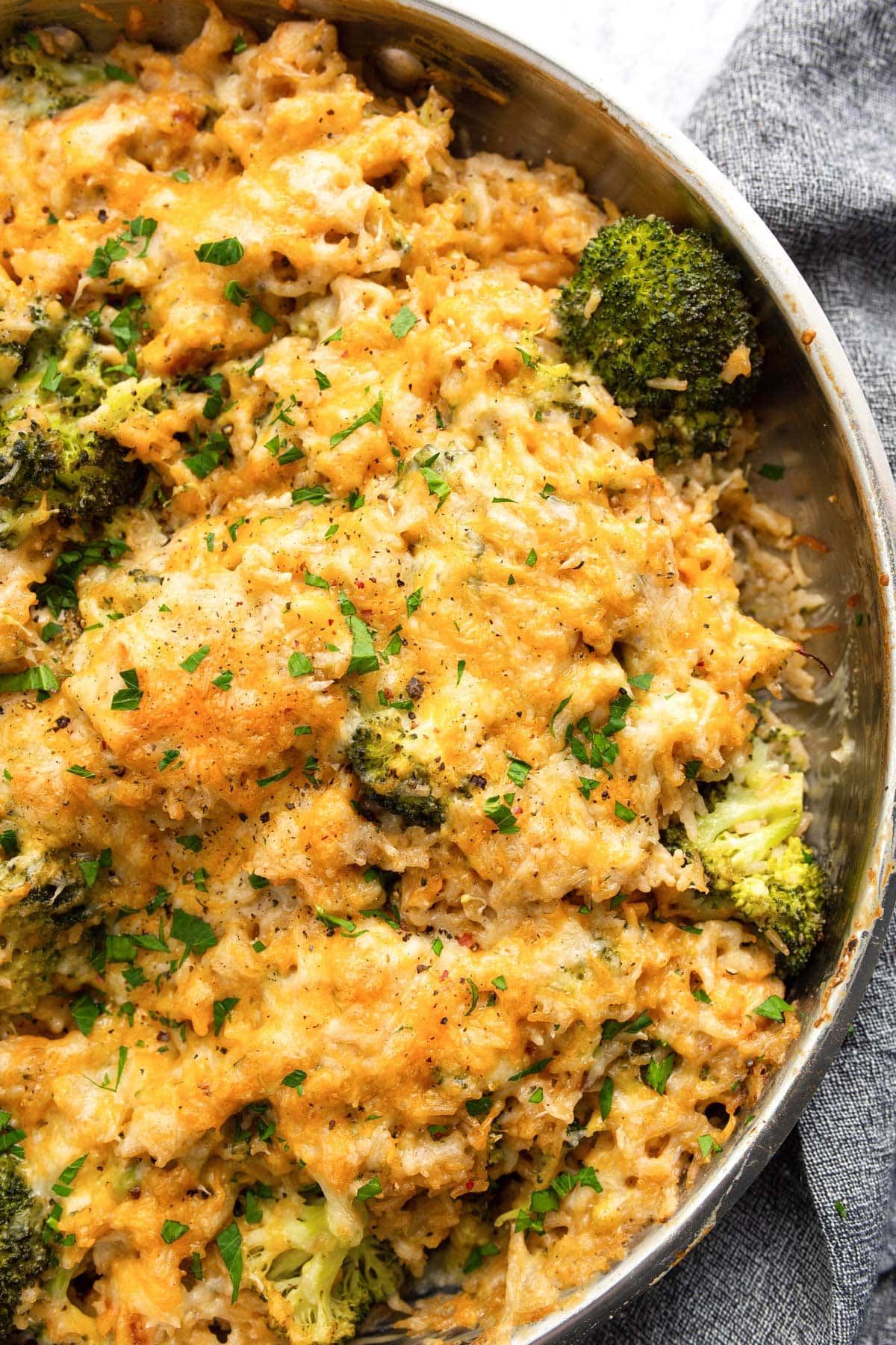 One pot chicken broccoli rice casserole in a large stainless steel skillet.