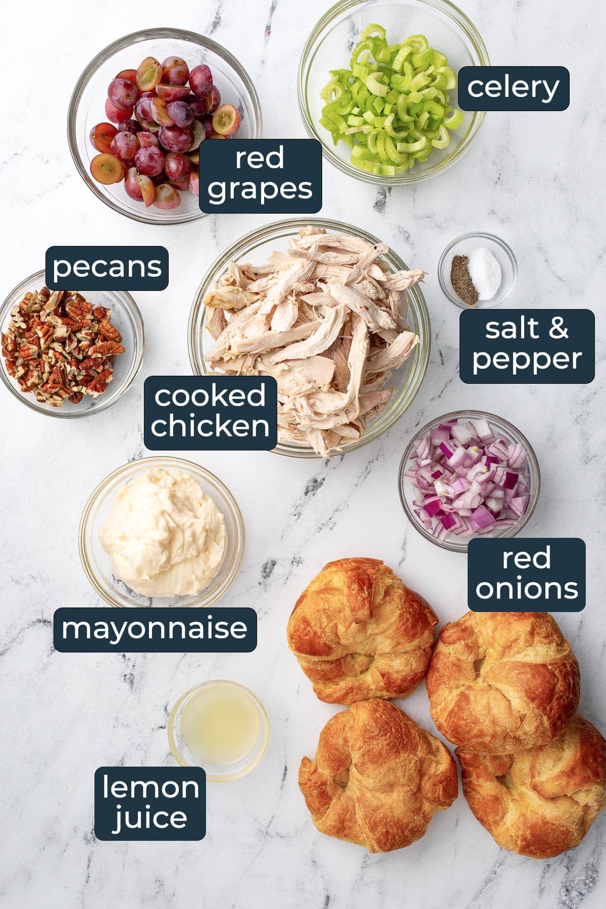 Ingredients for making chicken salad in prep bowls.