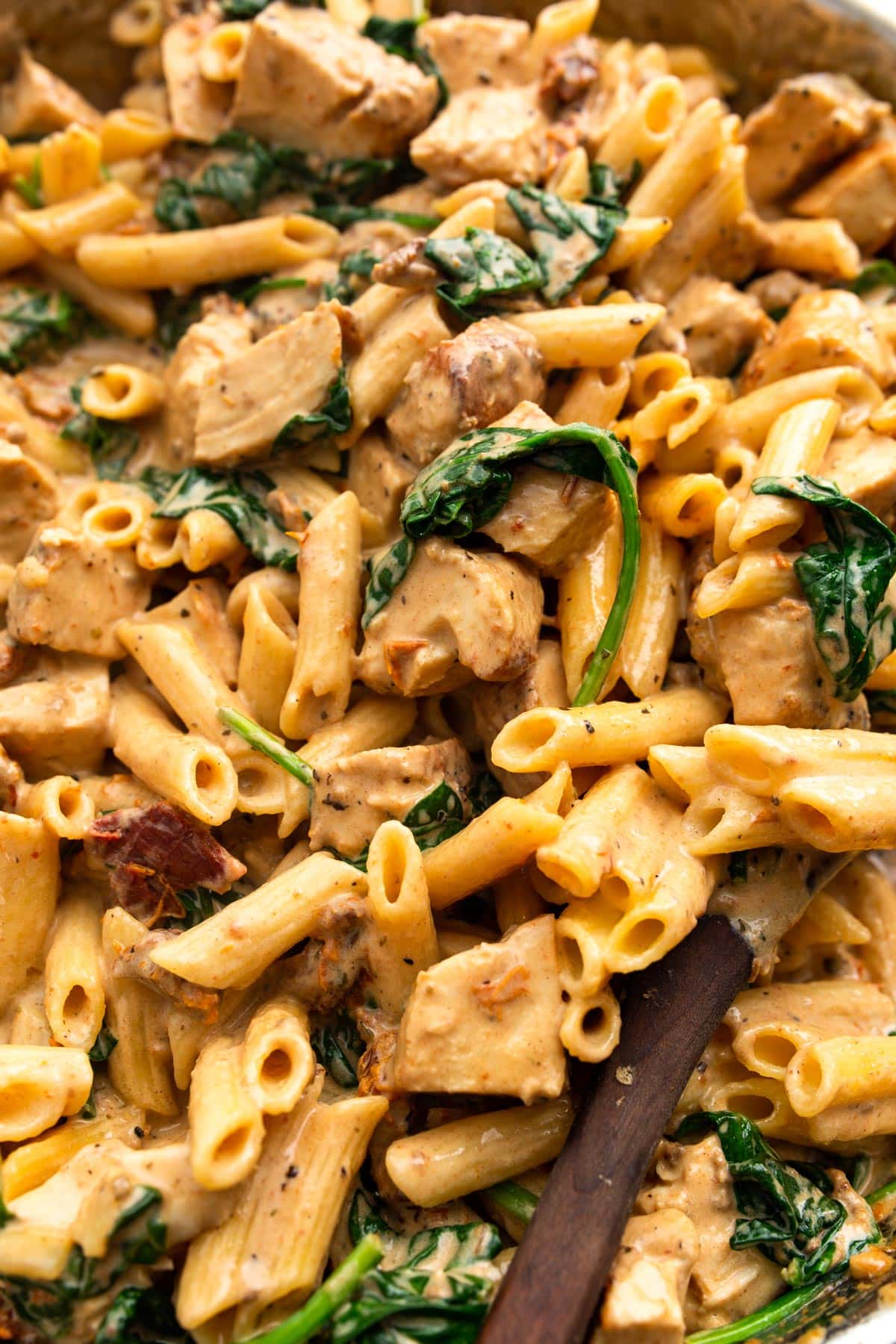 A close up shot of creamy Tuscan chicken pasta.