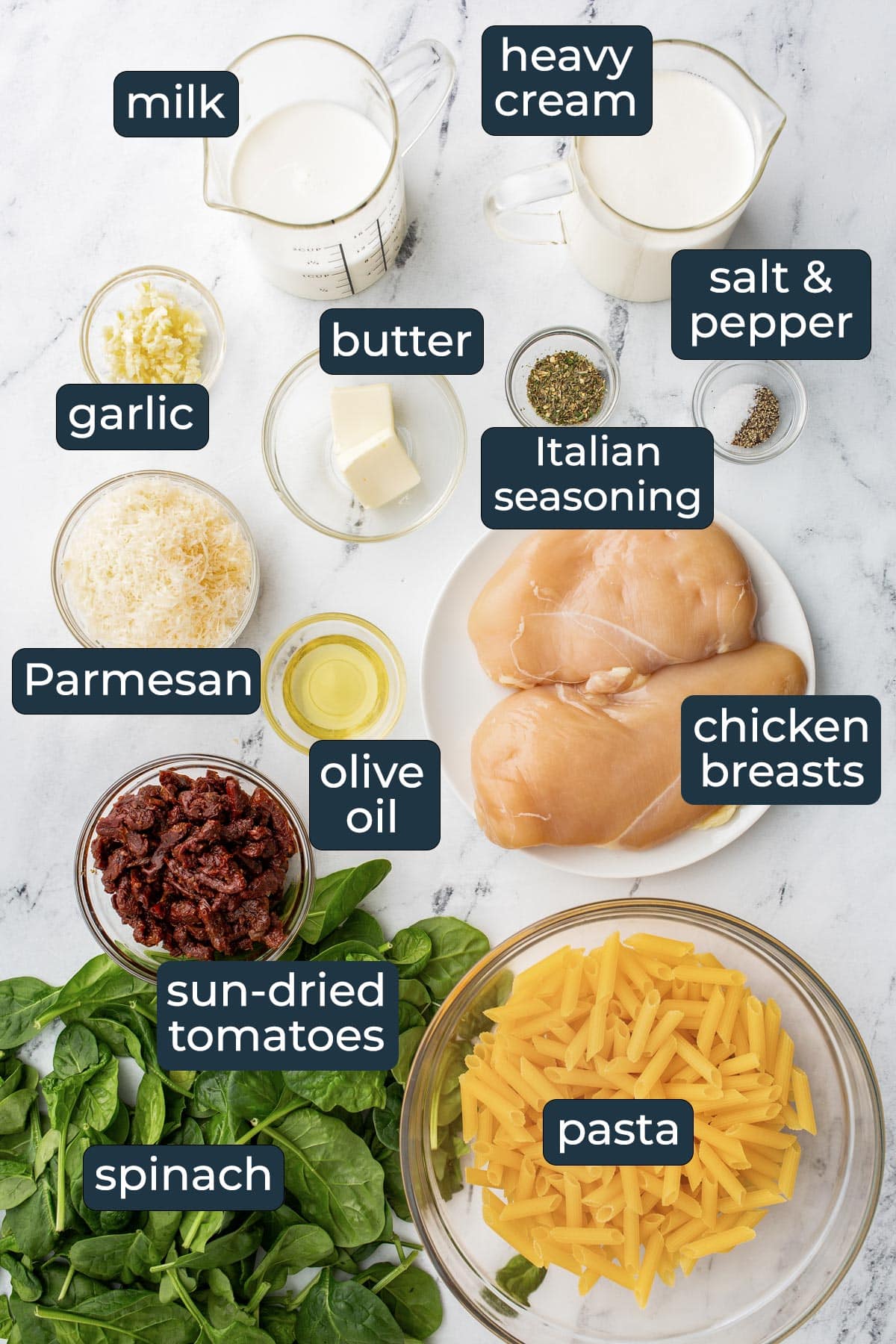 Ingredients for making creamy Tuscan chicken pasta in prep bowls.