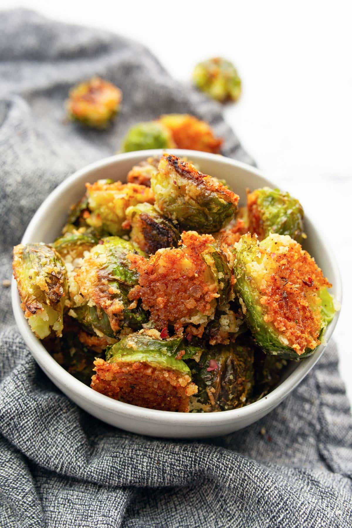 A handful of crispy garlic Parmesan brussels sprouts in a small bowl.