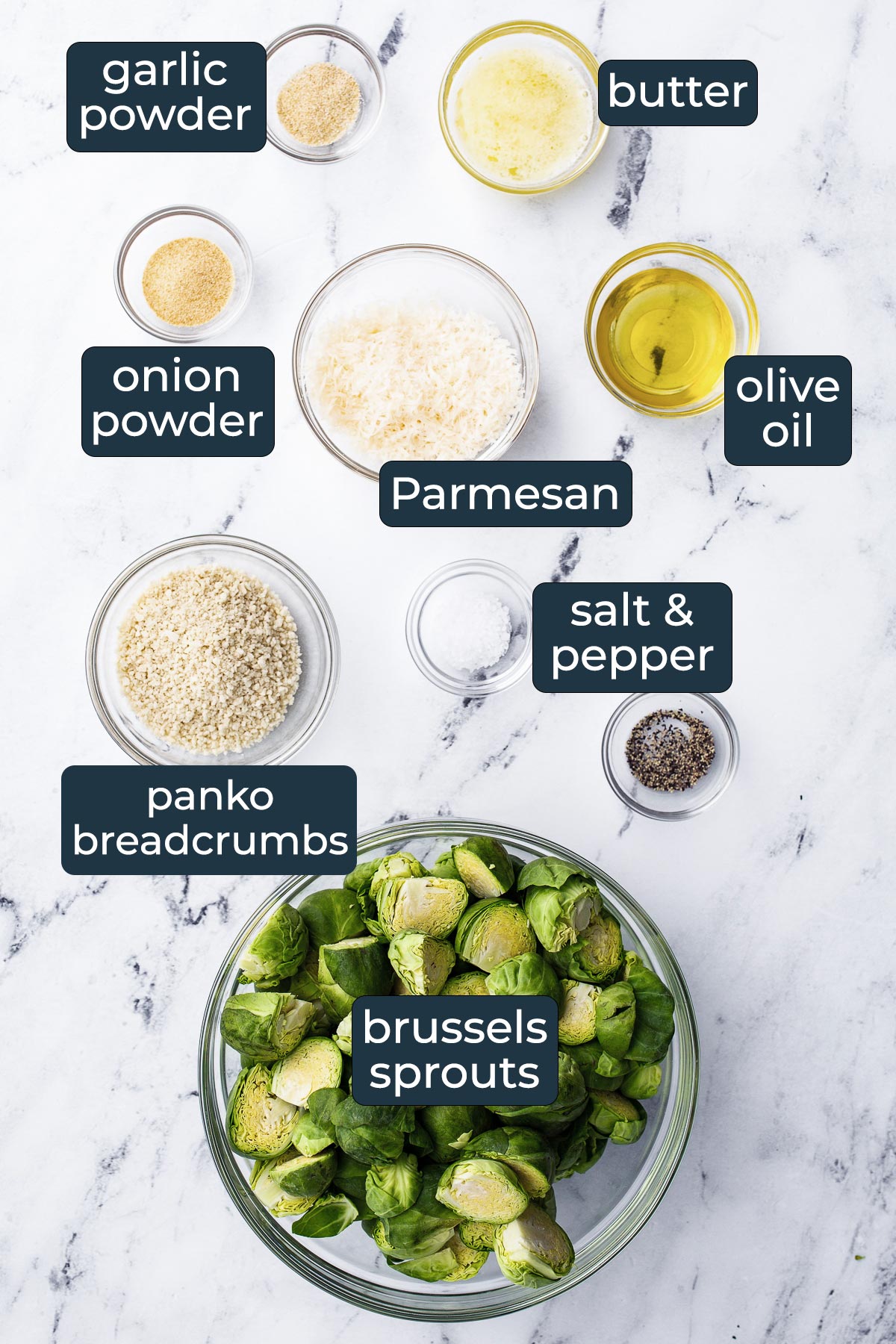 Ingredients for making crispy garlic Parmesan brussels sprouts in prep bowls.