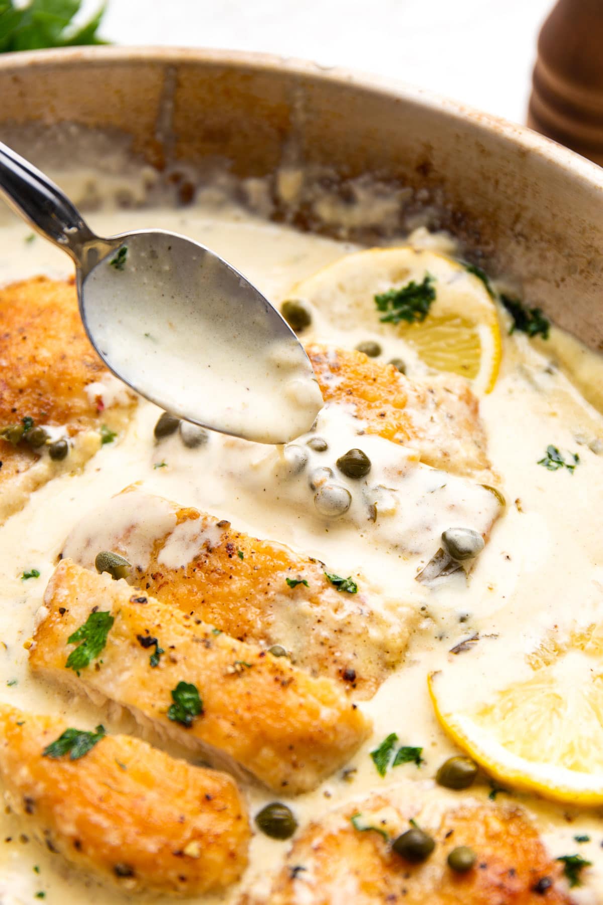 Some cream sauce spooned over the lightly battered creamy lemon chicken piccata.