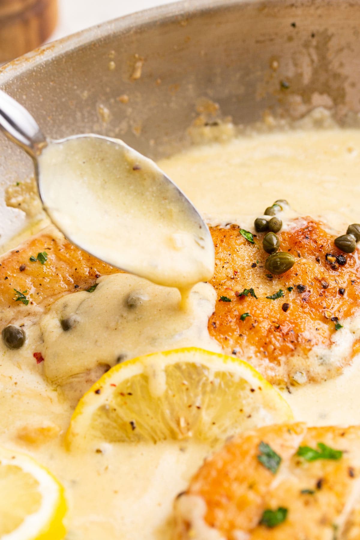 Some cream sauce spooned over the lightly battered creamy lemon chicken piccata.