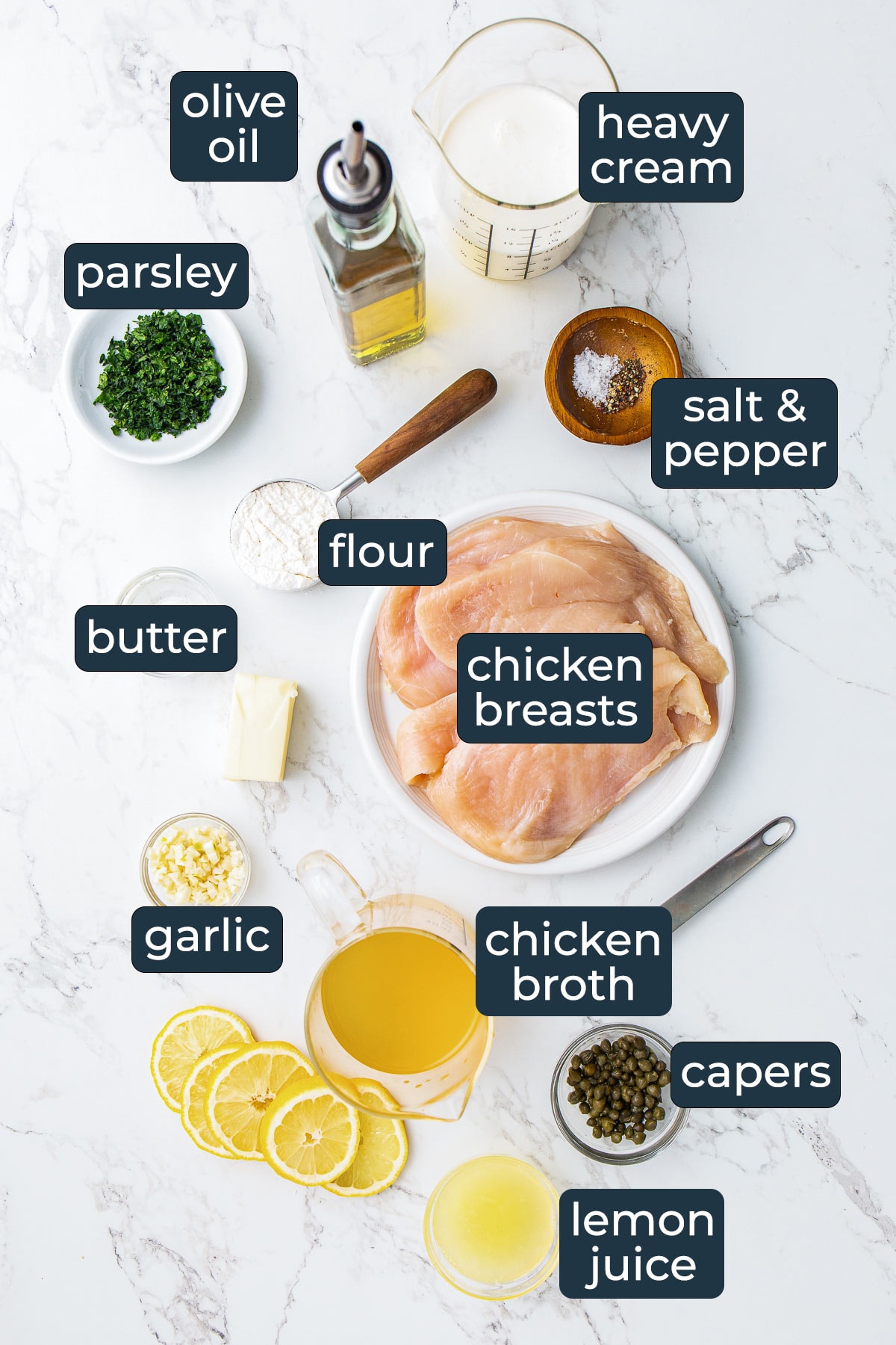 Ingredients for making creamy lemon chicken piccata in prep bowls.