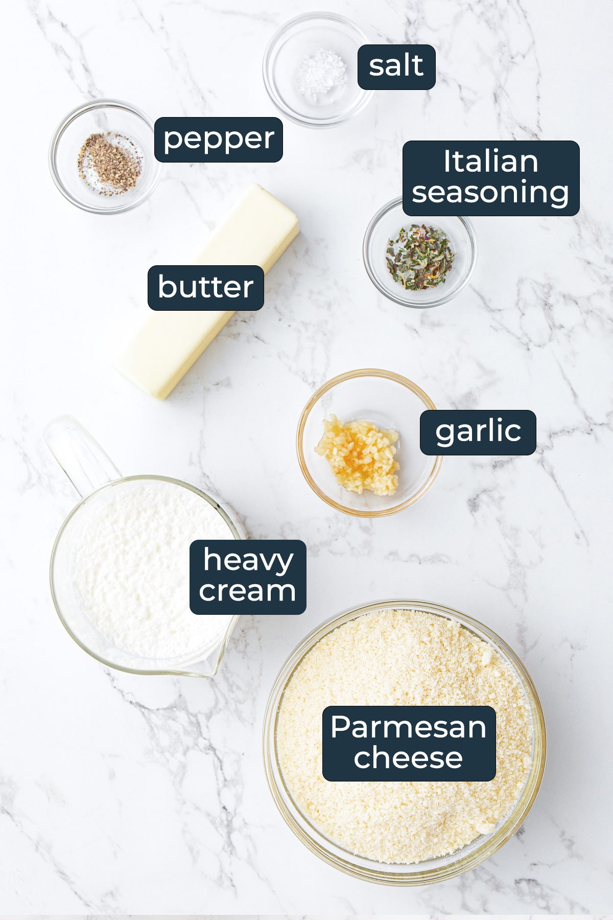 Ingredients for making homemade Alfredo sauce in prep bowls.
