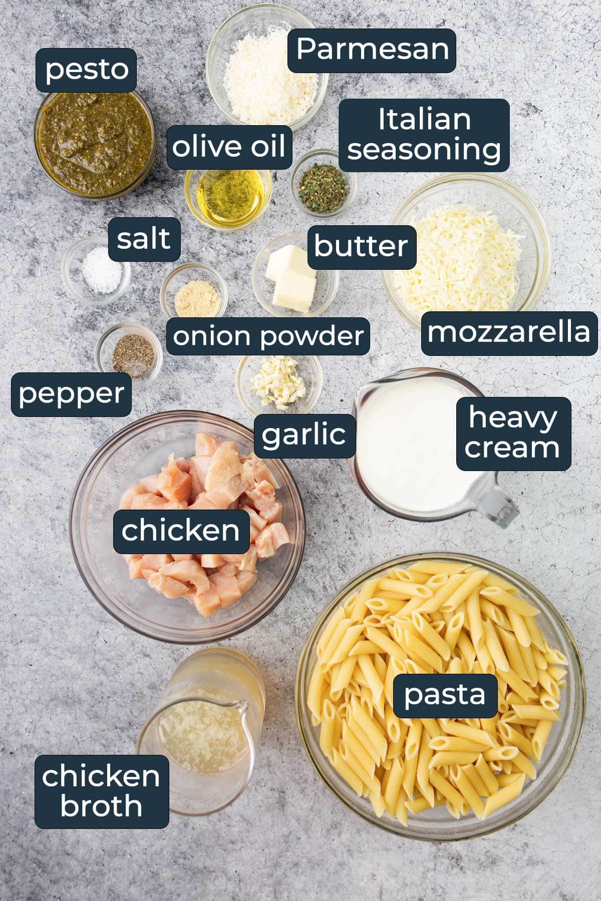 Ingredients for making creamy pesto chicken pasta in prep bowls.