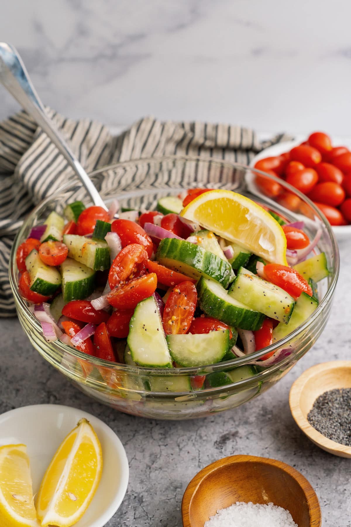 Cucumber tomato salad in a glass mixing bowl.